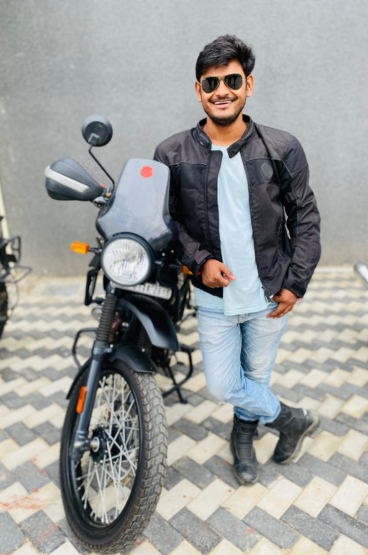Virendra Singh standing with his himalayan 411 bike